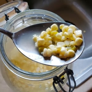 Southern sour corn in a spoon