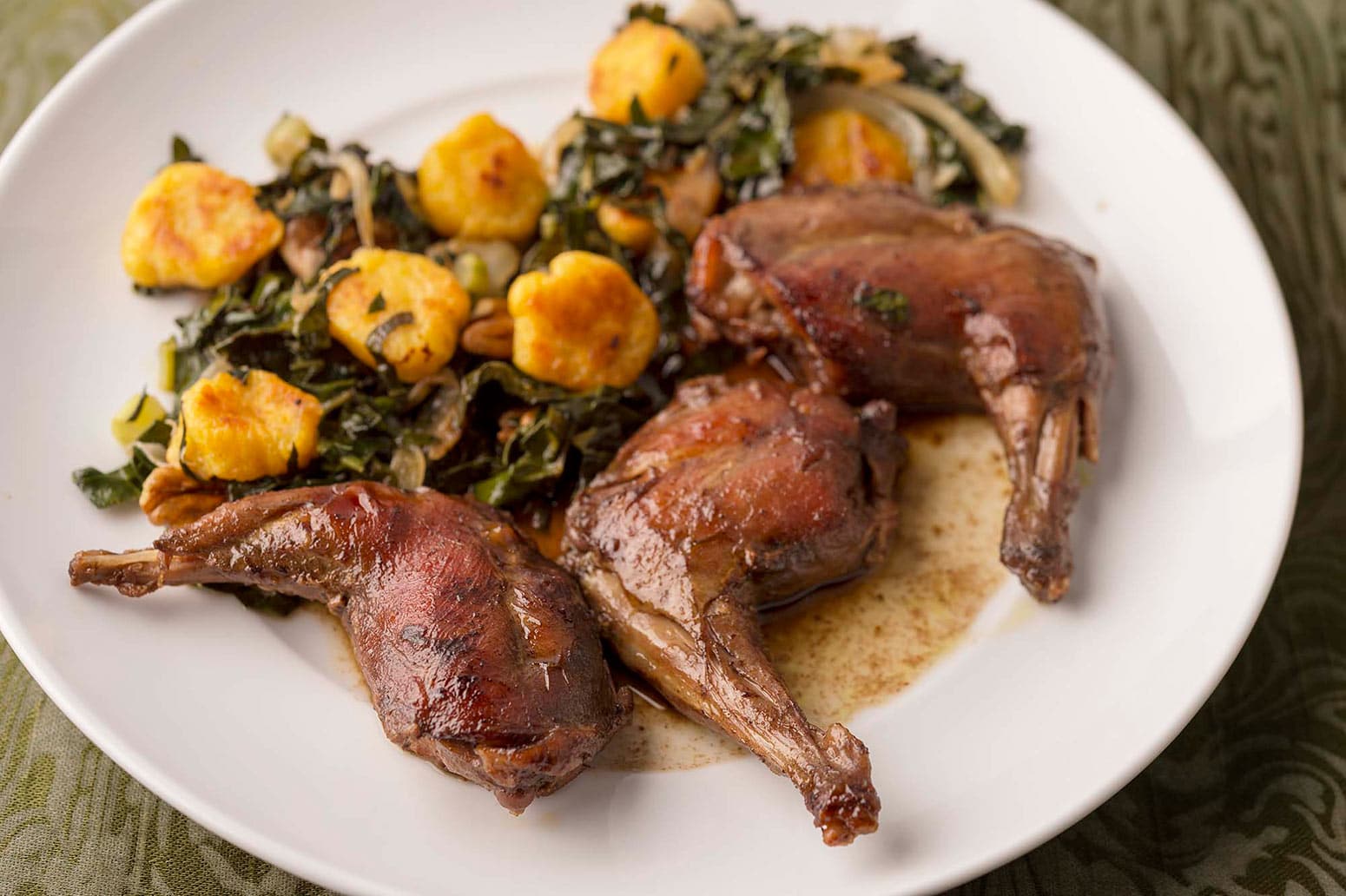 Drunken squirrel and dumplings on a plate with greens