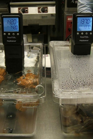 Two sous vide machines, cooking potatoes.