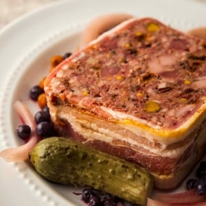 A slice of wild game terrine with pickles