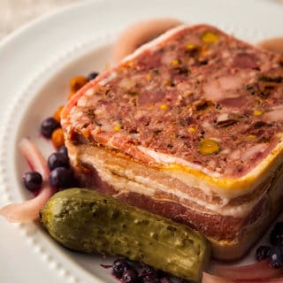 A slice of wild game terrine with pickles