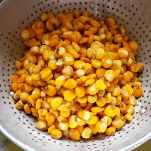 Finished nixtamal in a colander.