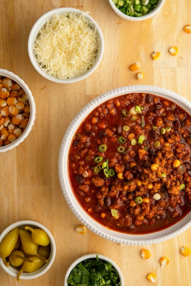 A bowl of turkey black bean chili with toppings