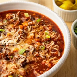 A bowl of turkey black bean chili loaded up with cheese