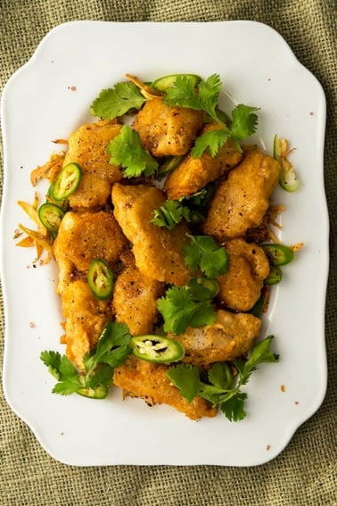 Chinese salt and pepper fish recipe, ready to eat on a platter