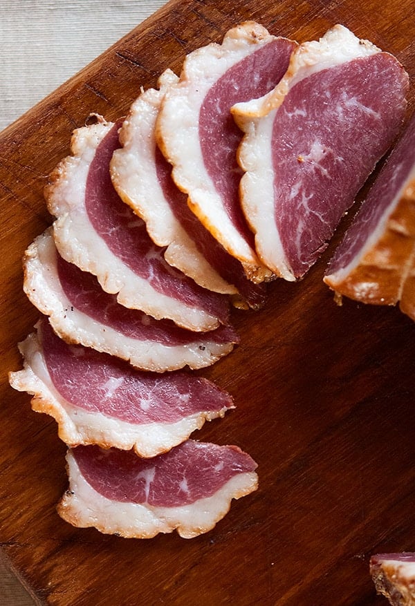 Slices of German smoked goose breast on a board