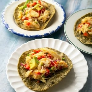 Three servings of tostadas de ceviche on appetizer plates