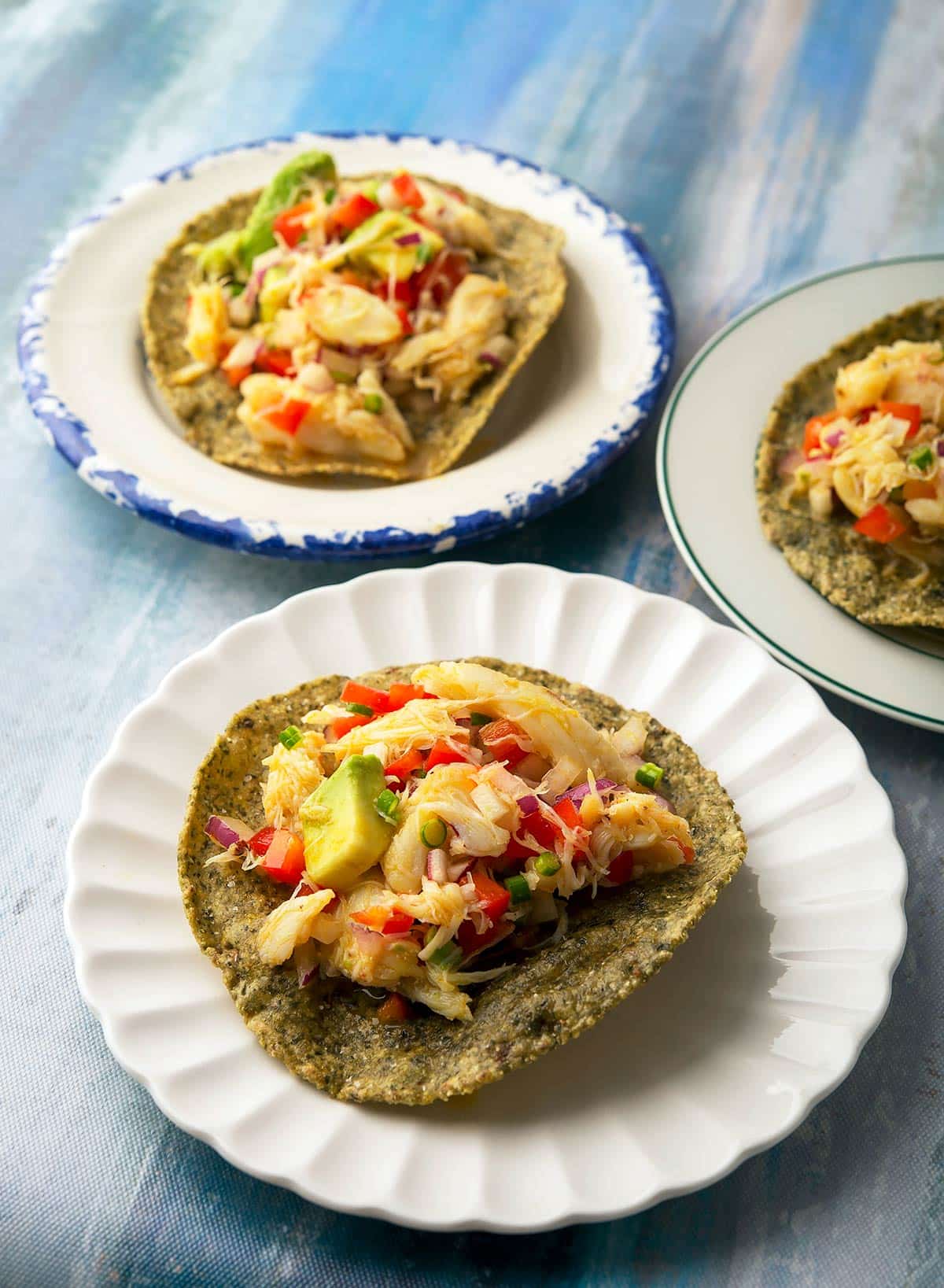 Three servings of crab ceviche on tostadas.