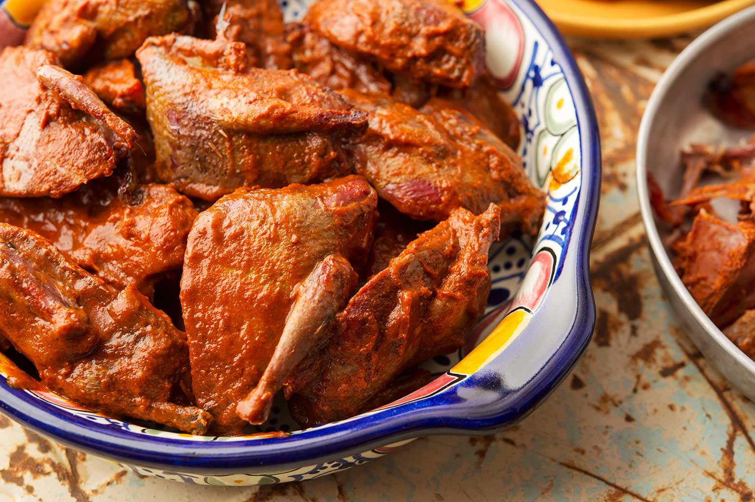 A bowl of smoked doves with guajillo sauce. 