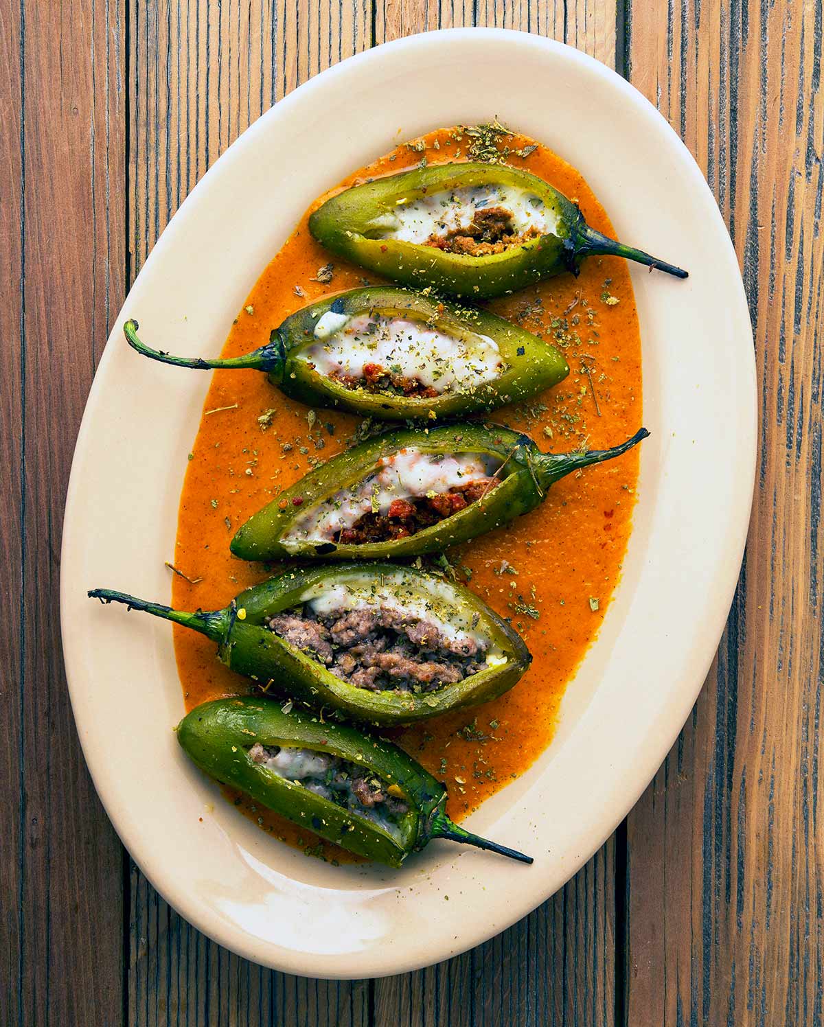 A platter of sausage stuffed jalapenos. 