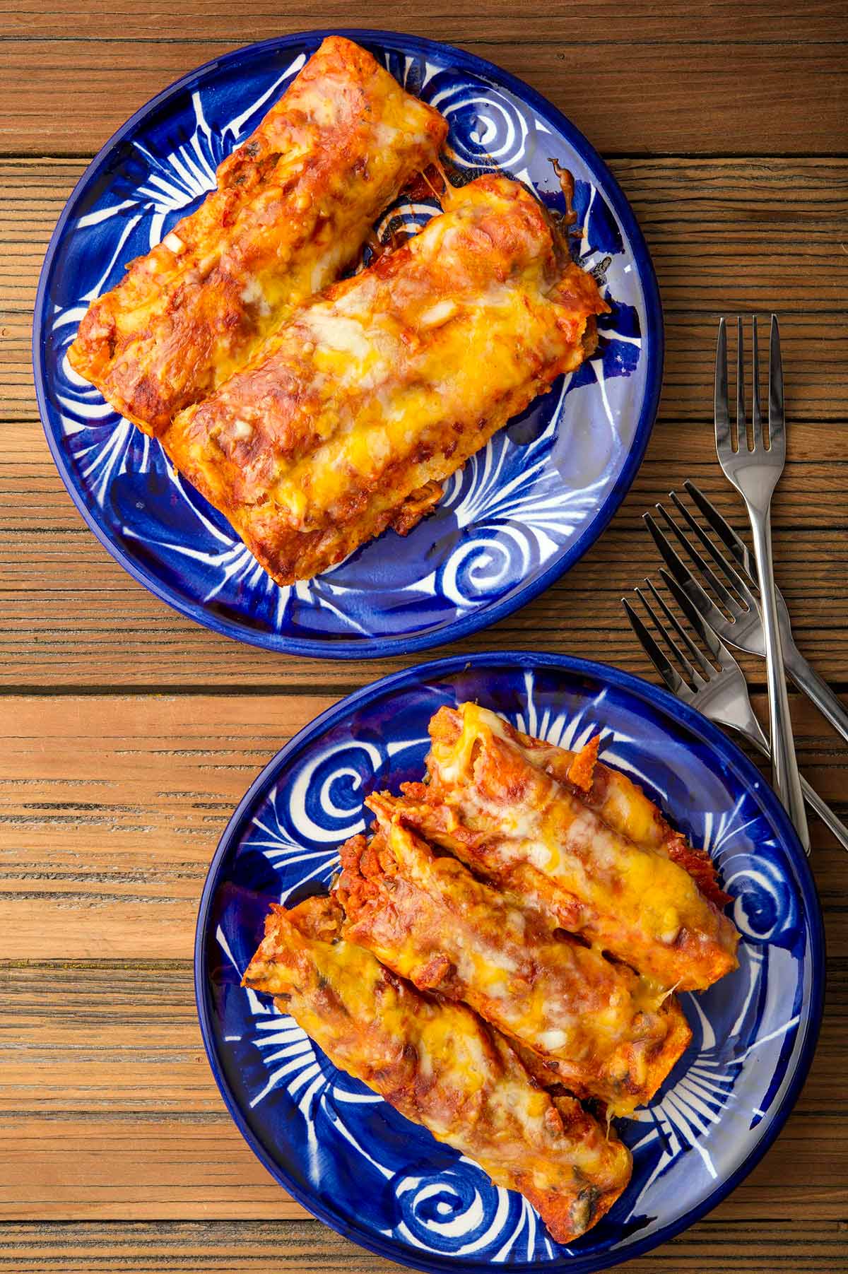 Two plates of enchiladas rojas