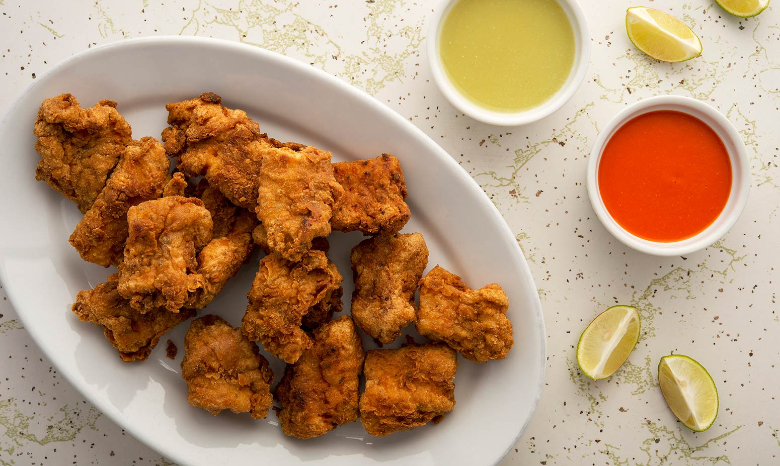 Mexican crispy fish with salsas on a platter