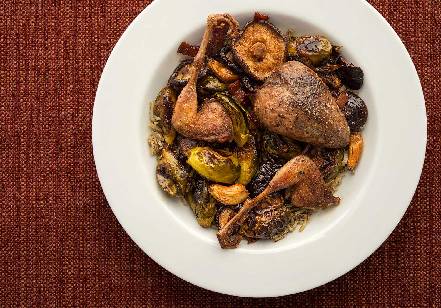 Pan seared woodcock with Brussels sprouts, in a shallow bowl. 