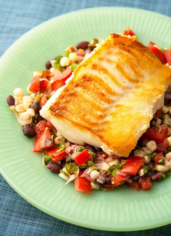 Pan seared cod on plate with crunchy salad