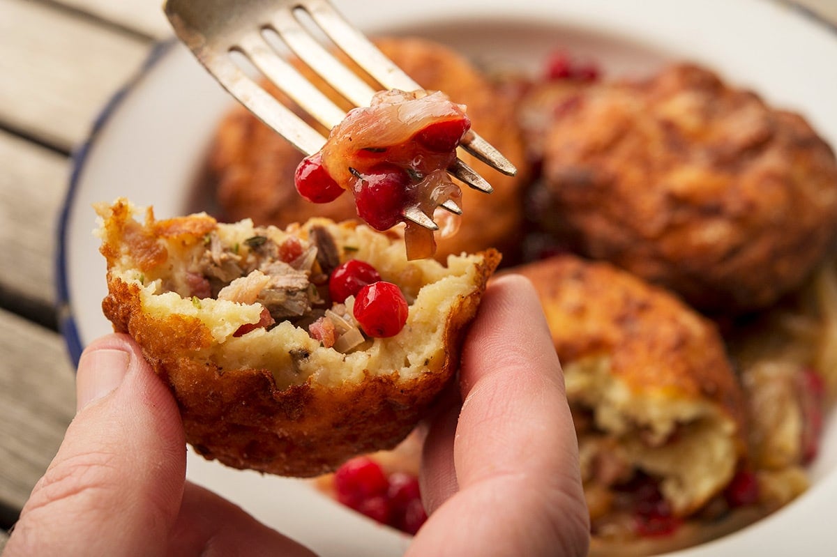 Eating a Swedish potato dumpling with lingonberries