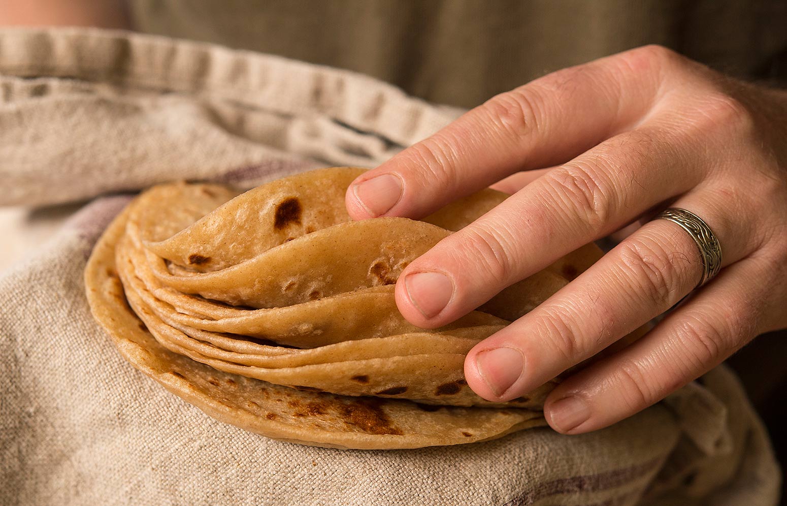 Finished homemade flour tortillas in a warming towel