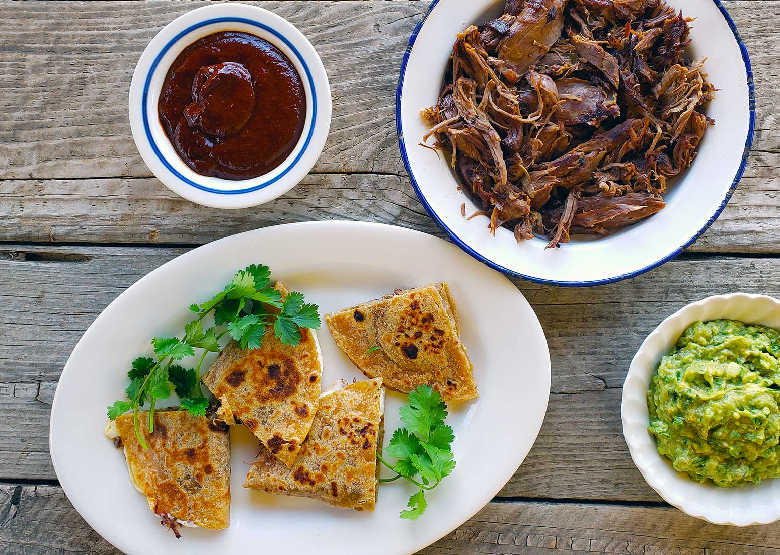 A plate of shredded jackrabbit with some rabbit quesadillas and salsa. 