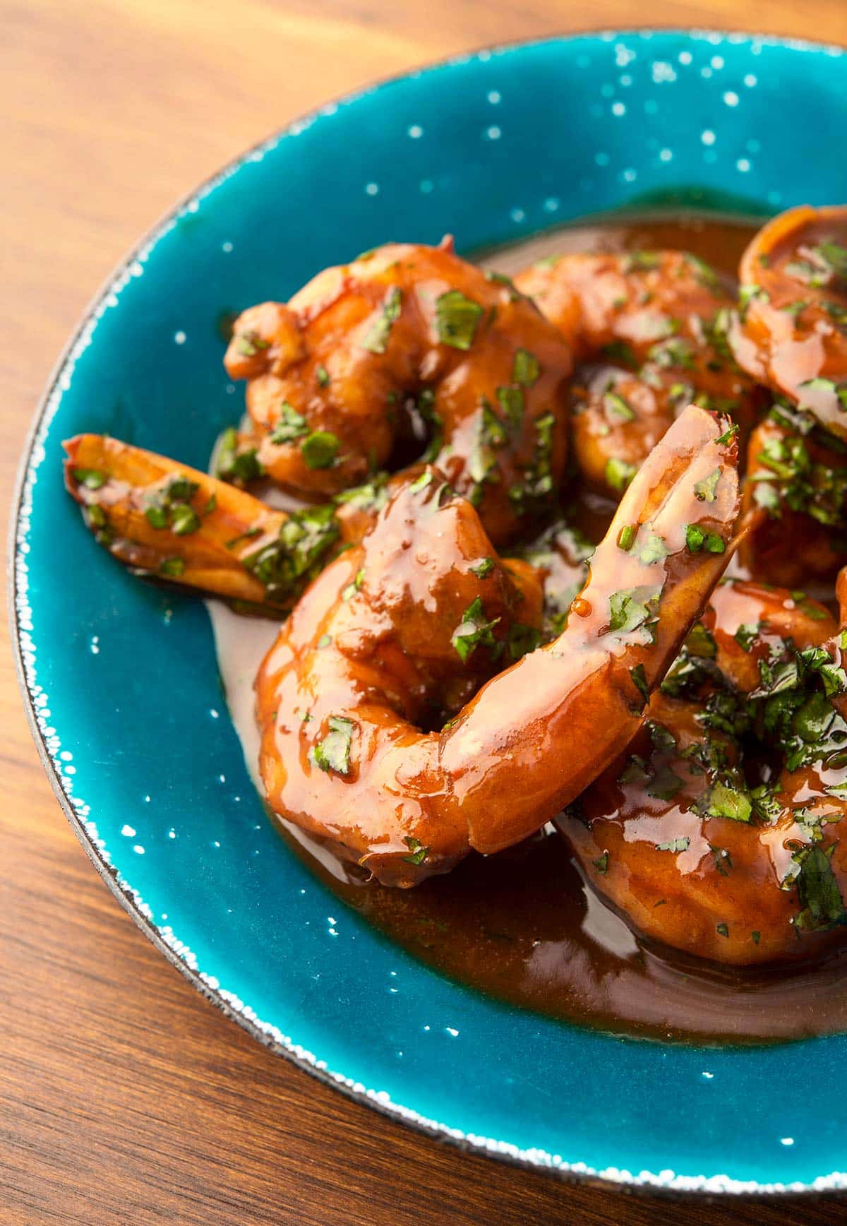 Close up view of New Orleans BBQ shrimp in a bowl. 