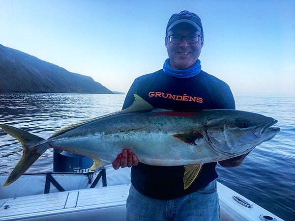 Hank Shaw holding a yellowtail. 