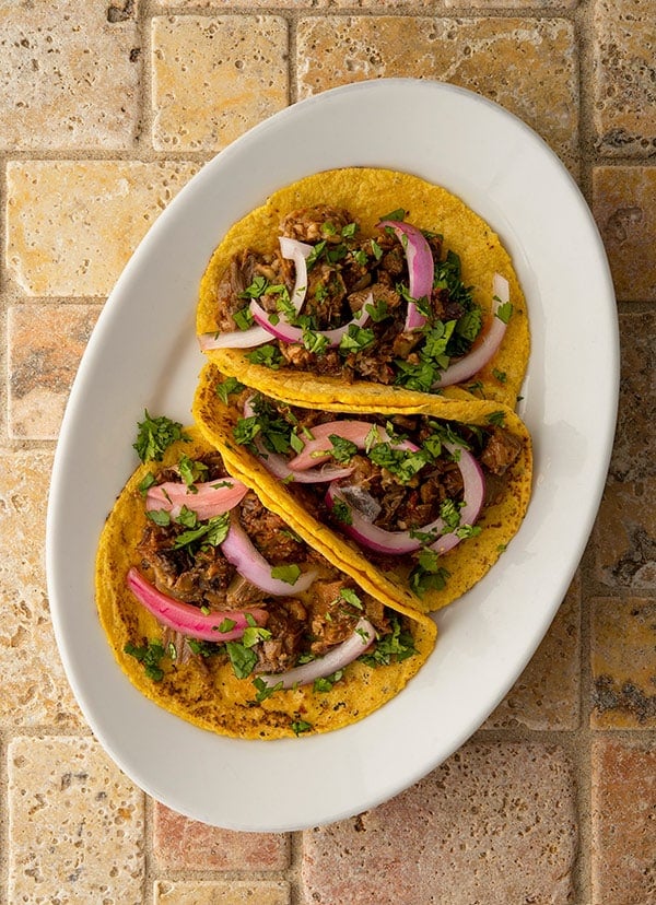 three tacos de cabeza on a plate