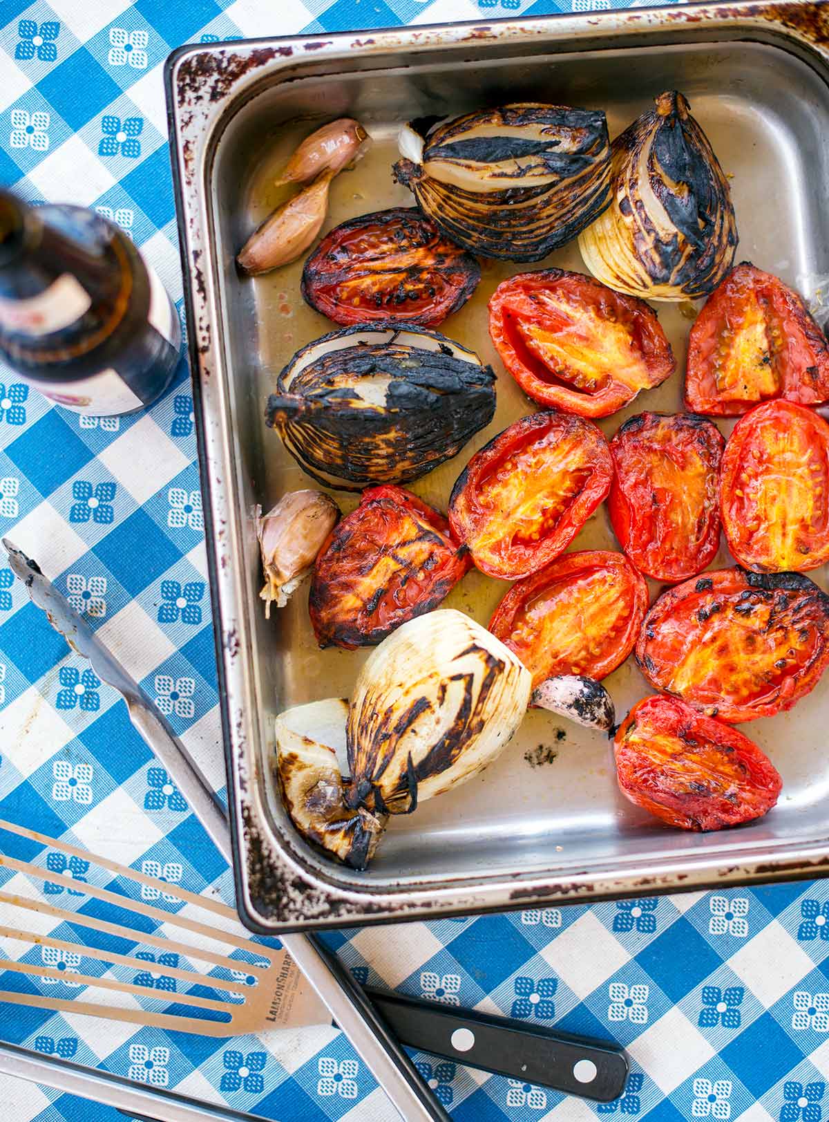 Charred vegetables for the salsa in a tray