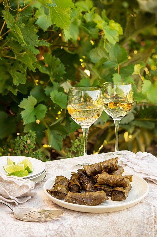 A plate of grape leaf tamales on the table