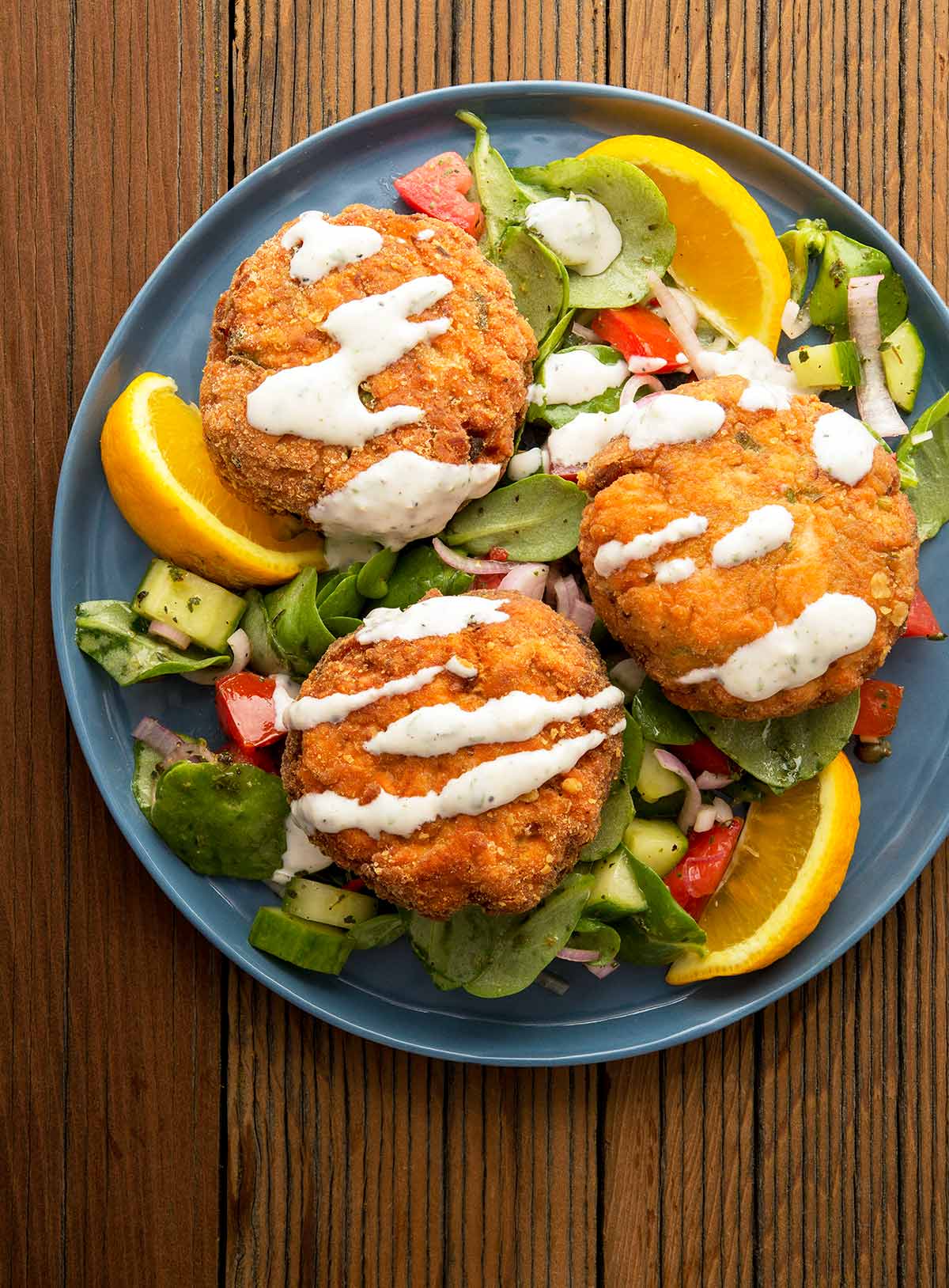 a plate of salmon patties with crackers.