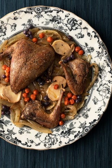 Pan roasted ptarmigan with mushrooms and northern berries.