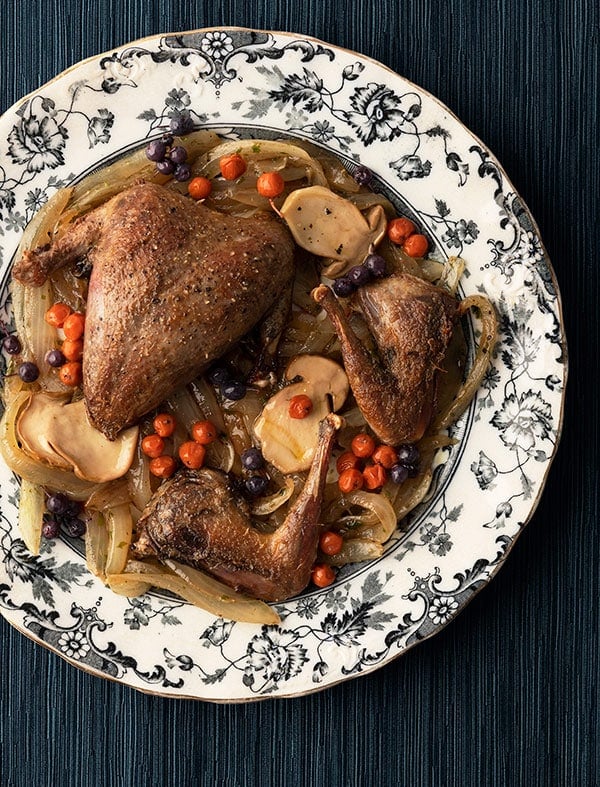 Pan roasted ptarmigan with mushrooms and northern berries.