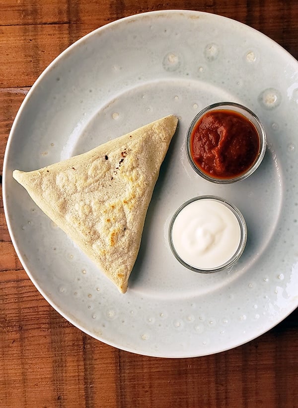 Mexican tetelas with salsa and crema