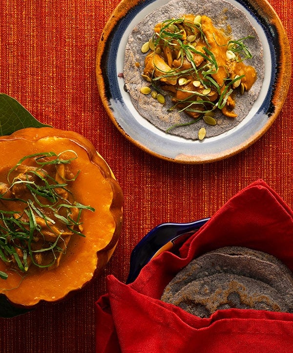 Overhead view of mole amarillo in a pumpkin.