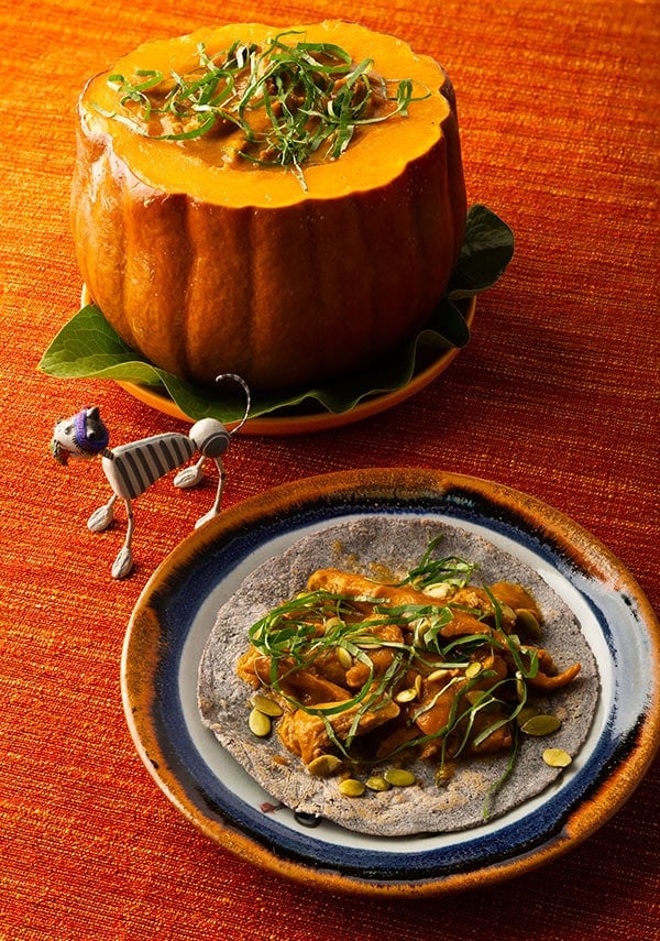 Mole amarillo on a taco, with more sauce in a pumpkin