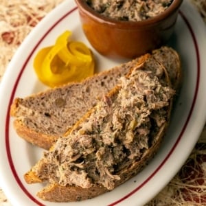 Rillettes spread on crusty bread on a platter