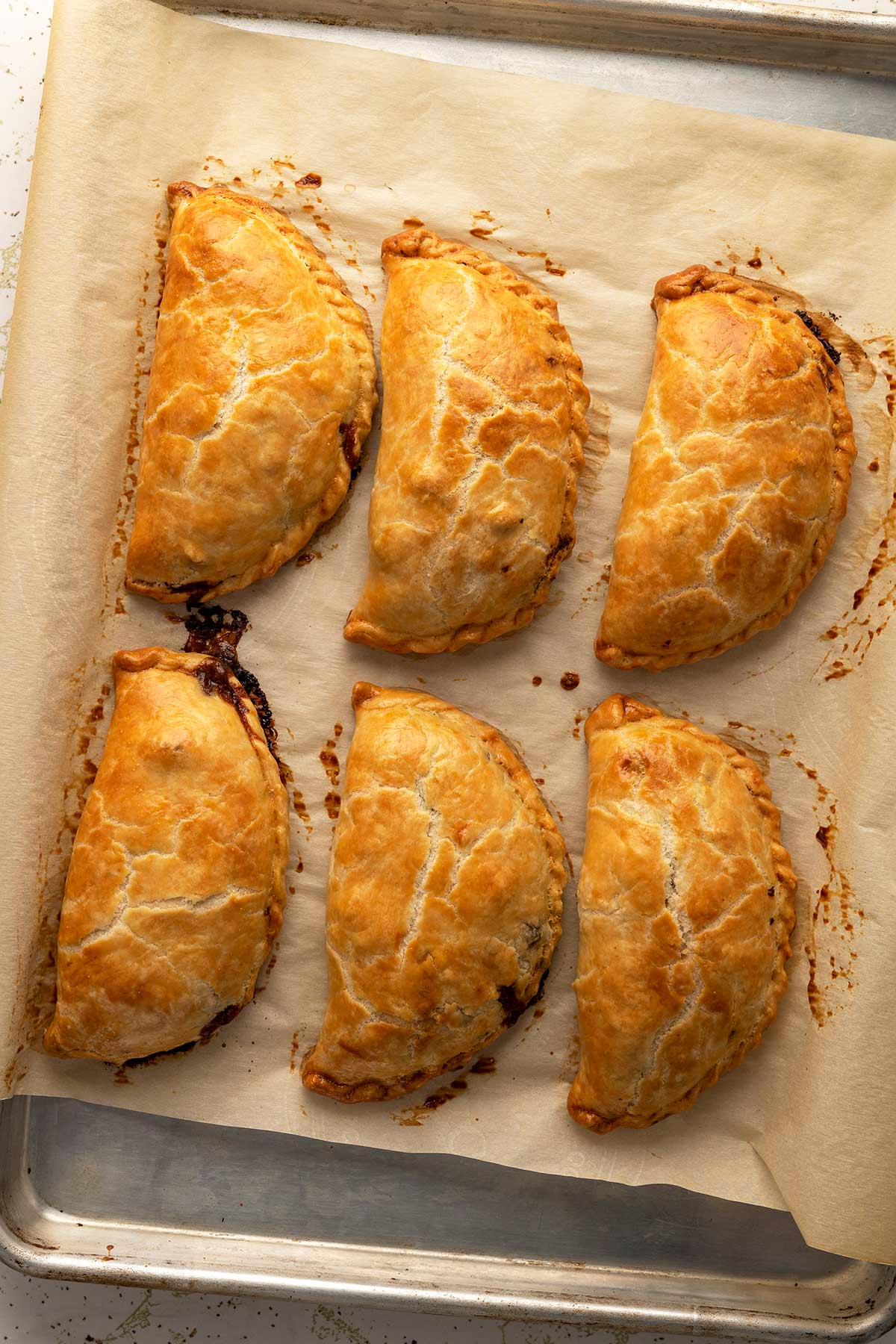 Venison pasties, cooling on a baking sheet