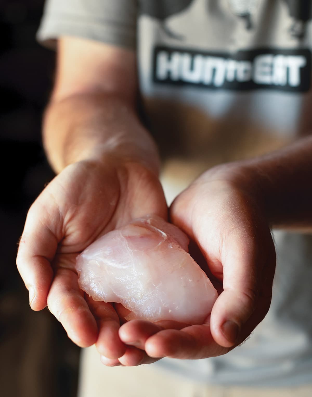 Holding a raw halibut cheek