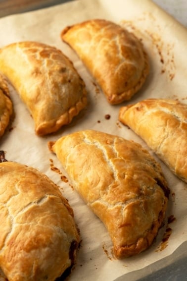 Finished pasty recipe, with pasties cooling on parchment paper