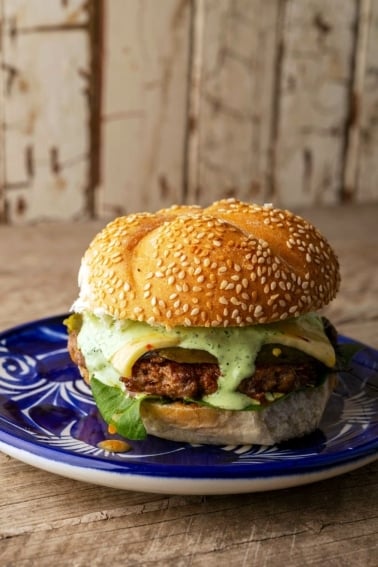 A chorizo burger on a plate, ready to eat.
