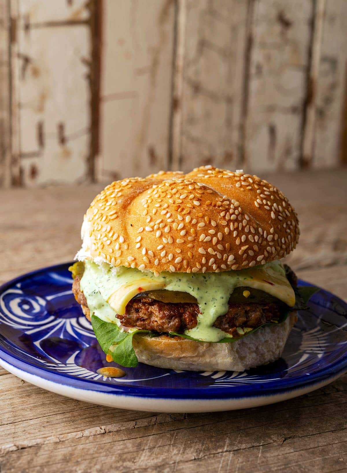 A chorizo burger on a plate, ready to eat. 