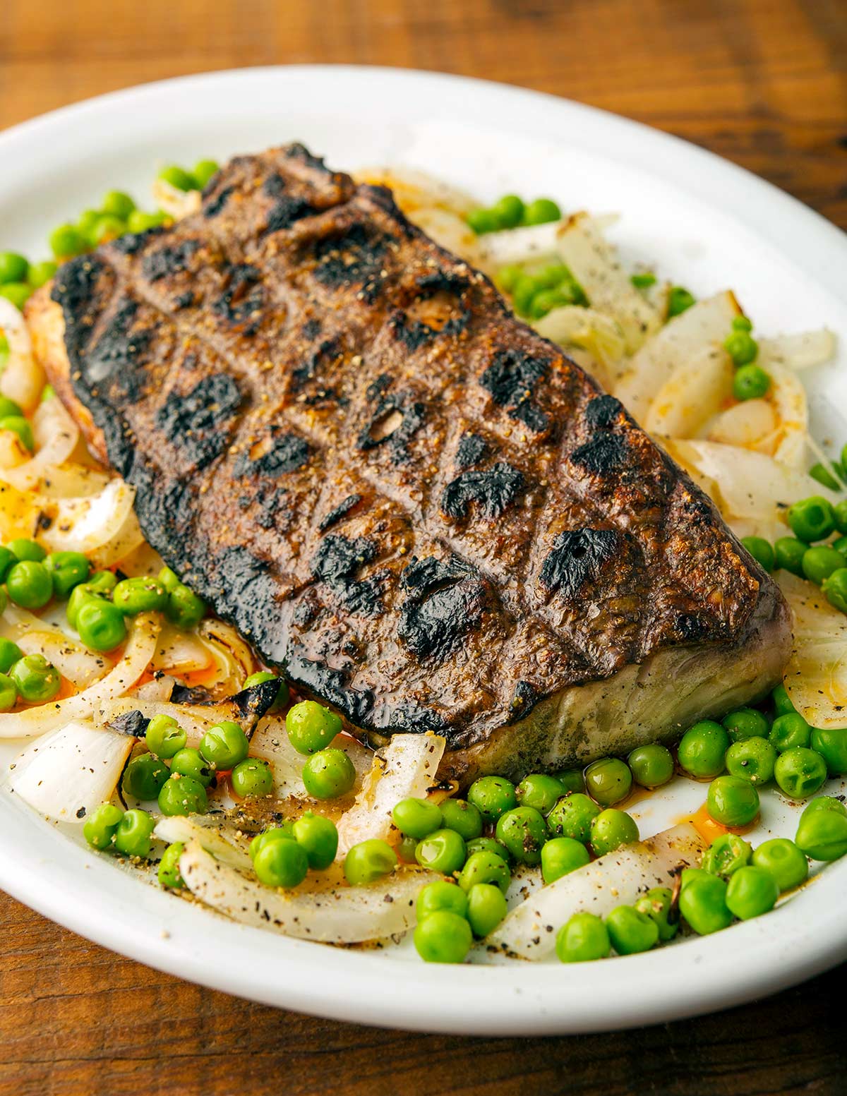 A salb of grilled fish with crispy skin on a plate