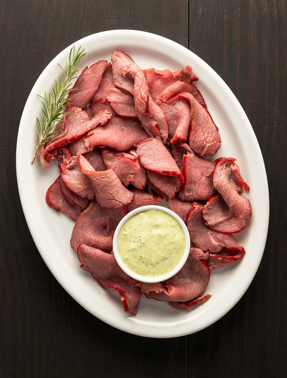 Sliced, smoked venison backstrap on a platter.