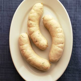 Three links of weisswurst on a plate