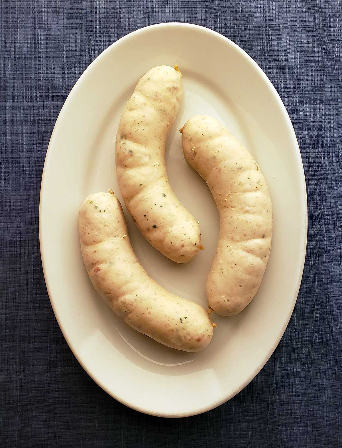 Three links of weisswurst on a plate