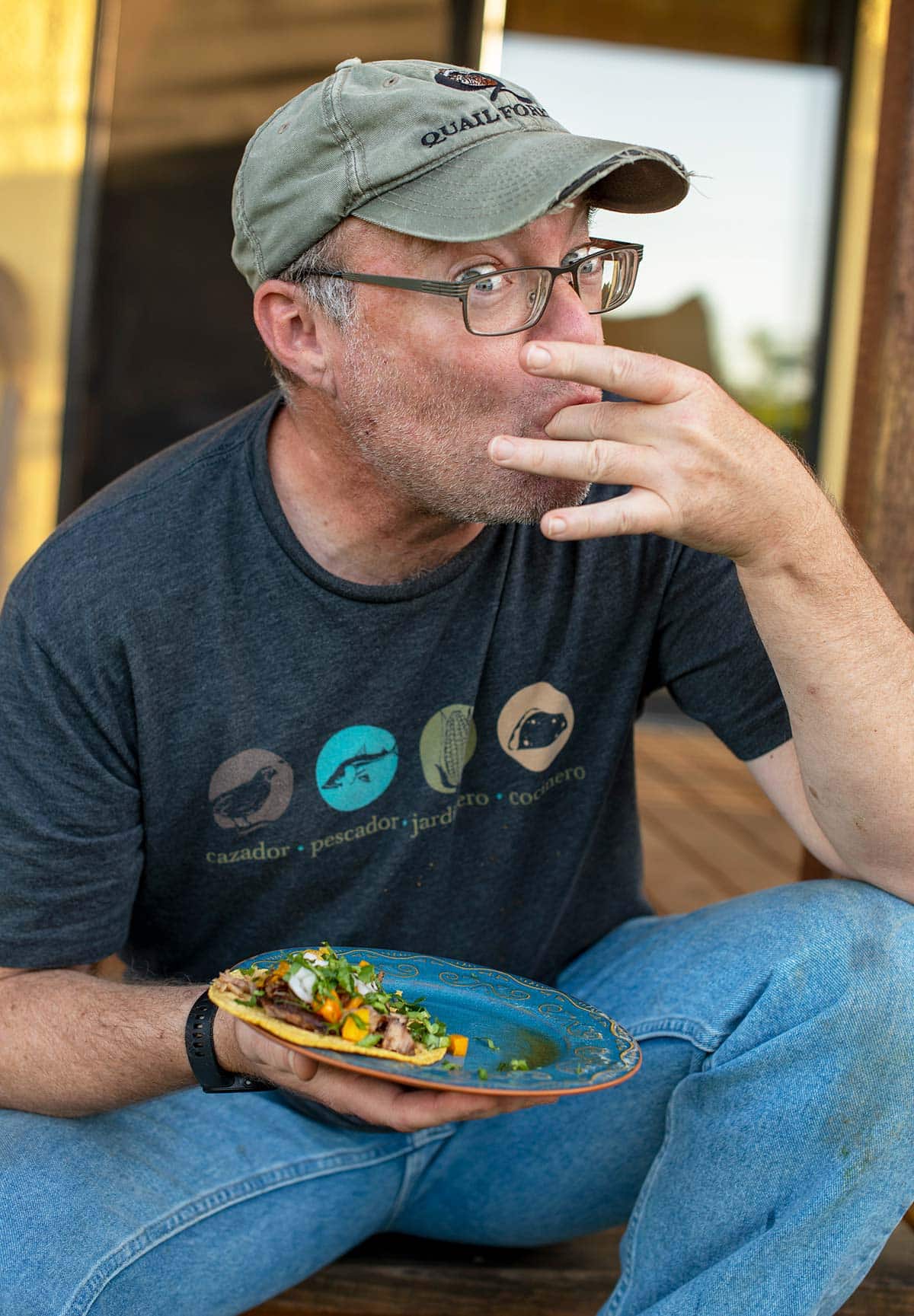 Hank Shaw eating authentic carnitas tacos