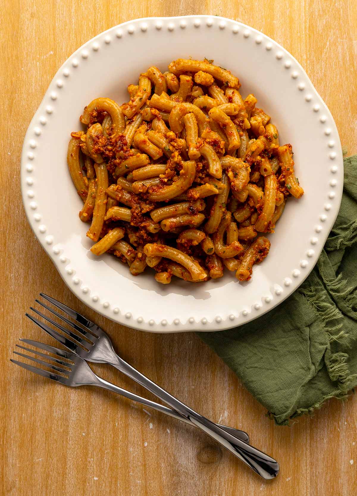 A bowl of pasta dressed with red pesto