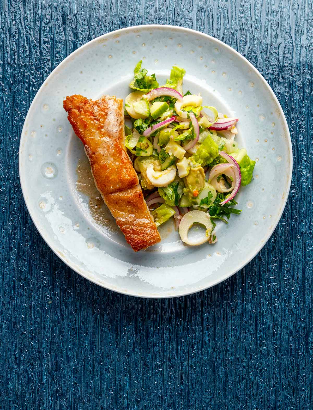 A plate of pan seared grouper with hearts of palm salad.