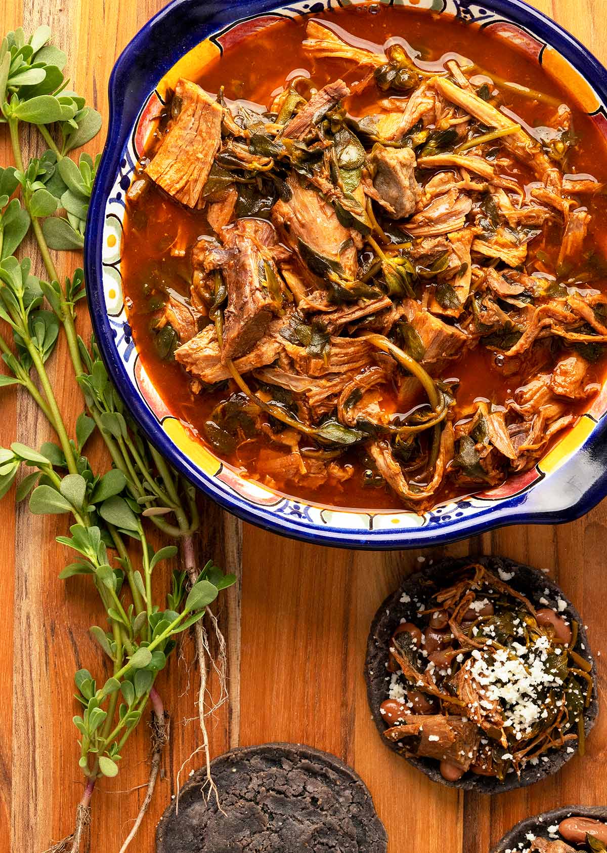 A bowl of puerco con verdolagas, pork with purslane