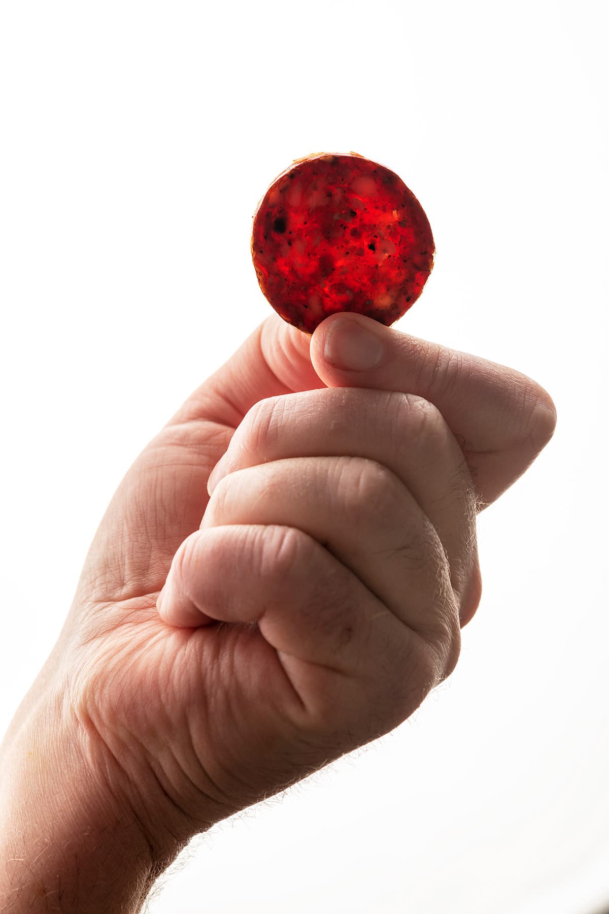 Holding a slice of venison summer sausage