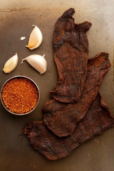 Smoked venison jerky with some of its main ingredients