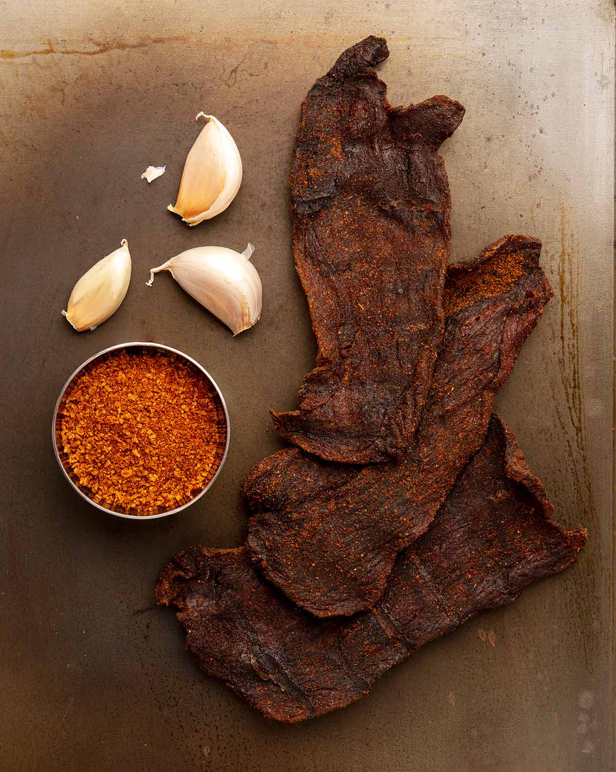 Smoked venison jerky with some of its main ingredients