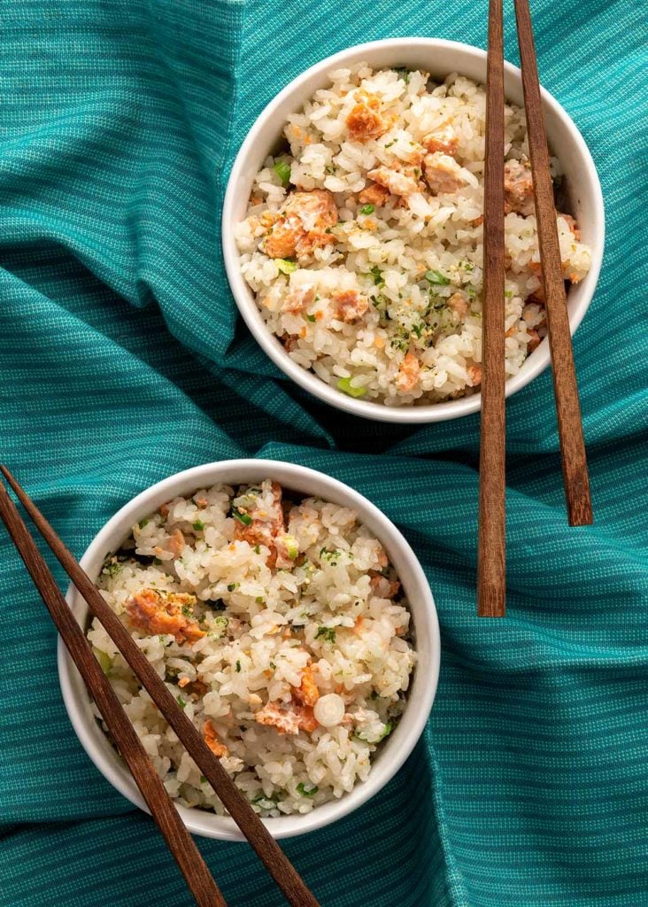 Two bowls of Japanese salmon rice with chopsticks.